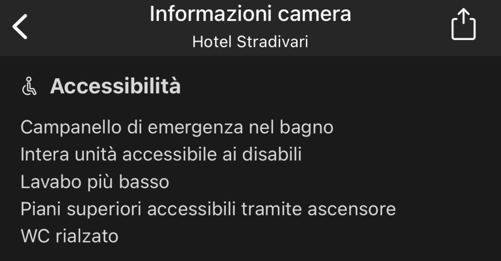 Screenshot delle informazioni sull'accessibilità della camera dell'Hotel Stradivari: campanello di emergenza nel bagno, unità accessibile, lavabo più basso, ascensore, wc rialzato